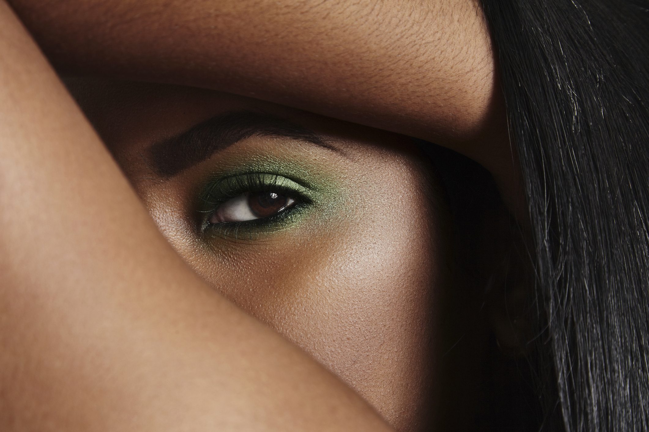 Close-up of woman's eye with green make up
