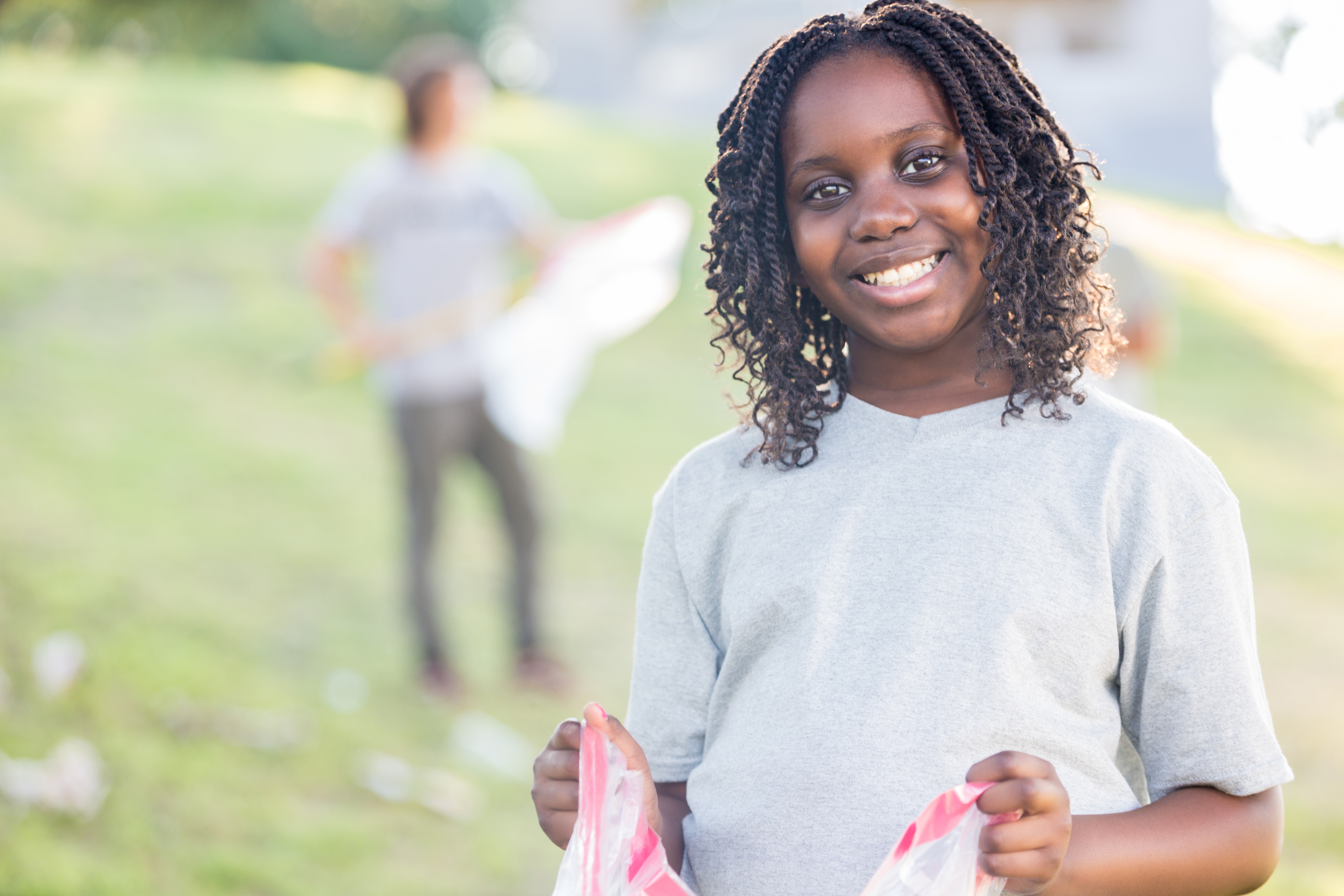 Beautiful African American girl helps with community cleanup