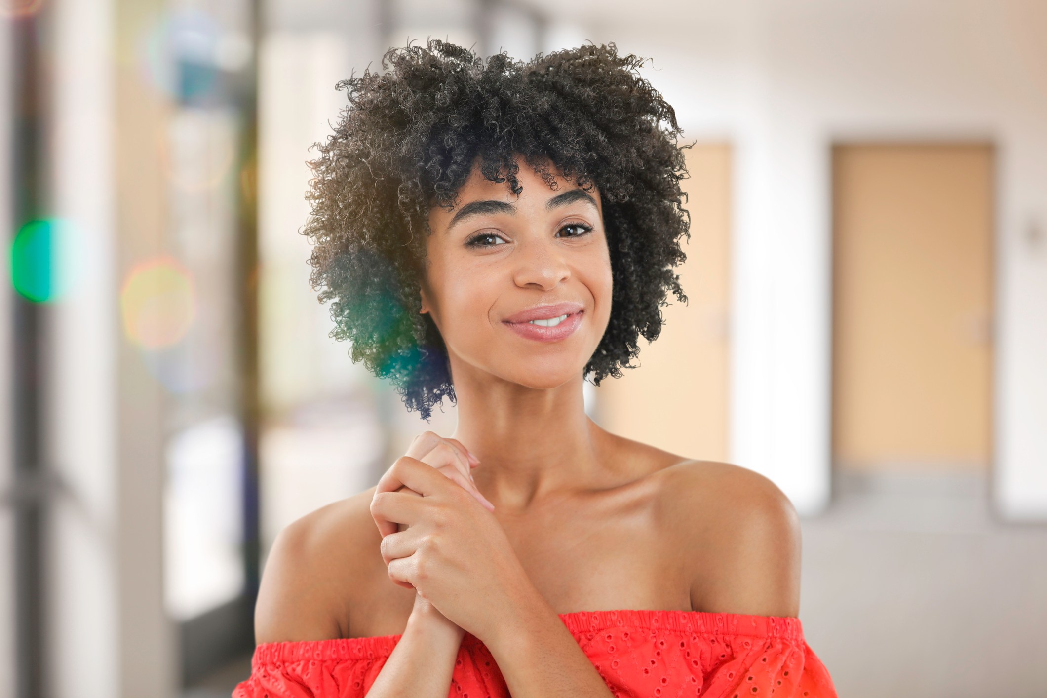 Smiling young woman in dress in office