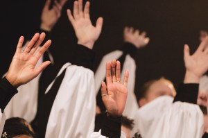 Church Choir's Hands Raised