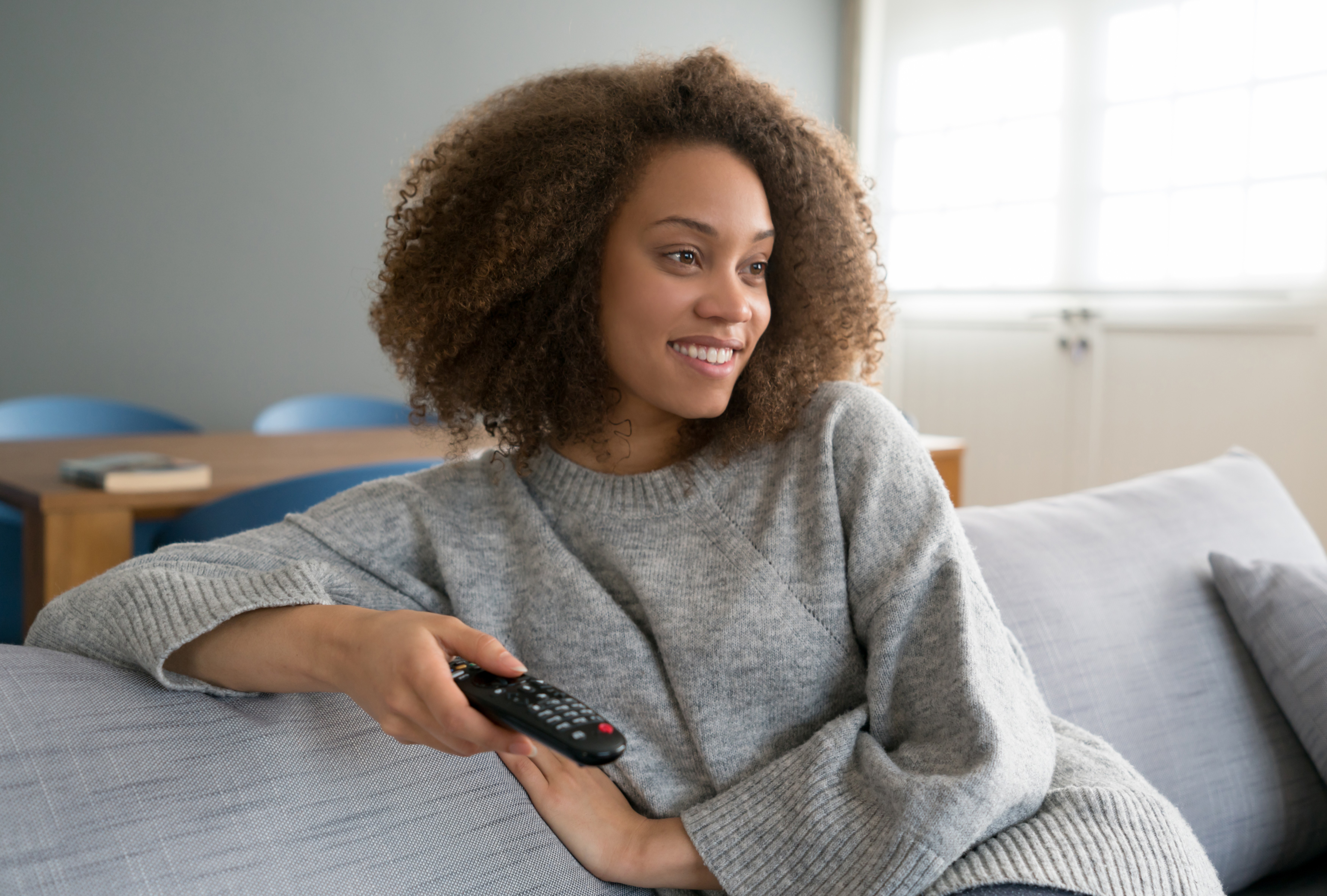 African American woman watching tv at home