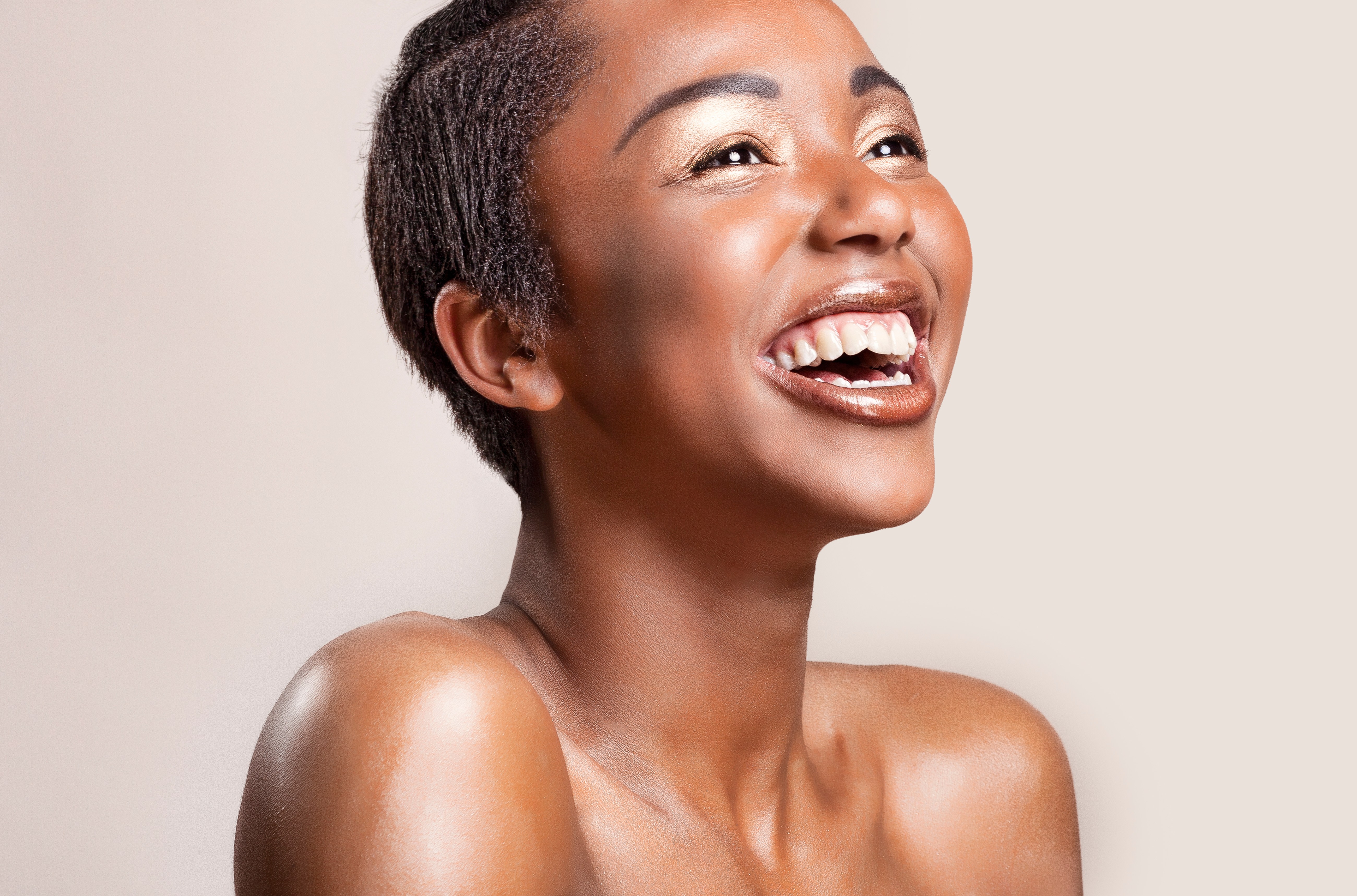 Portrait of a happy woman with glowing shiny skin