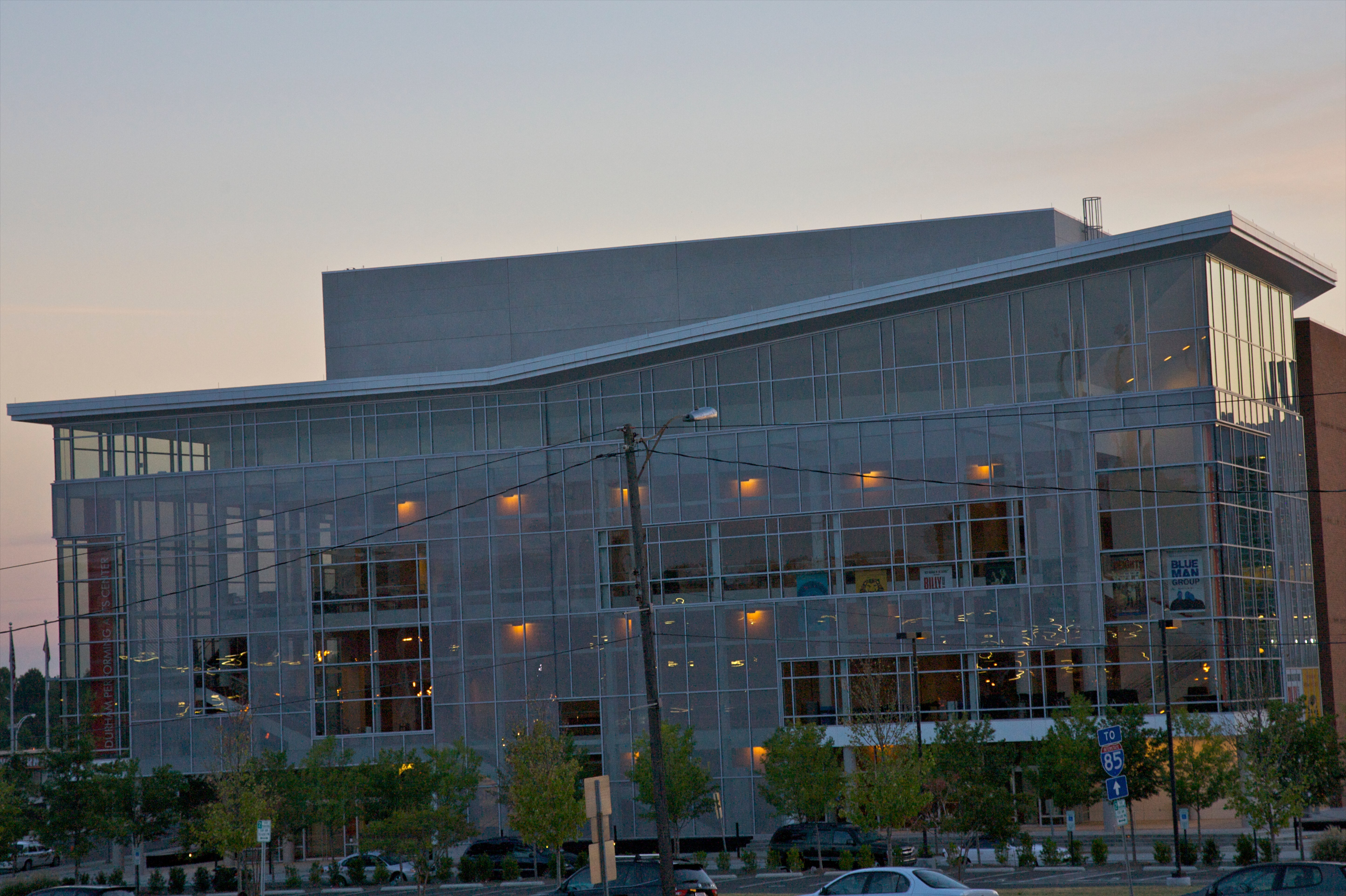 Contemporary glass-faced building at dusk.