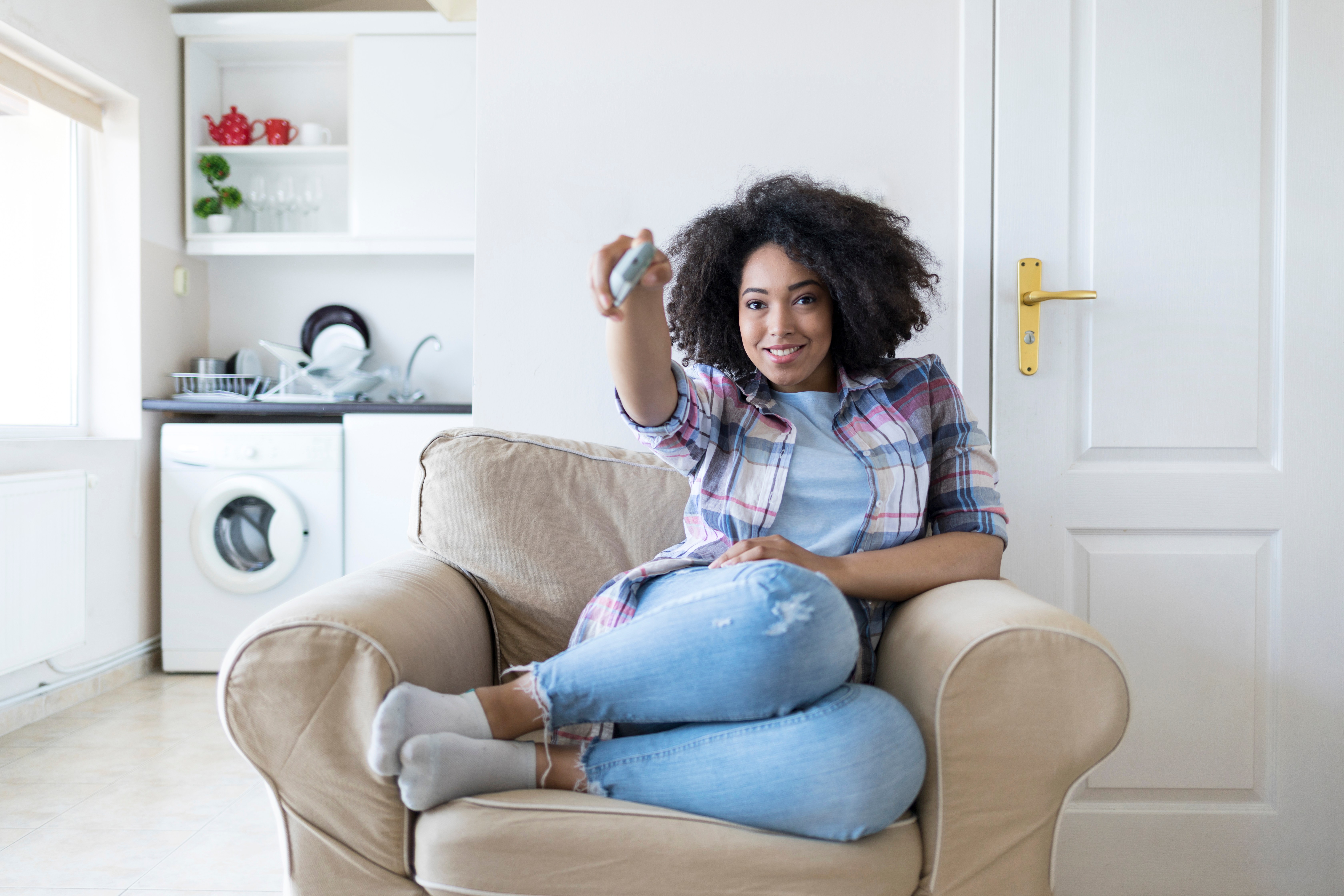 Woman resting at home and watching TV