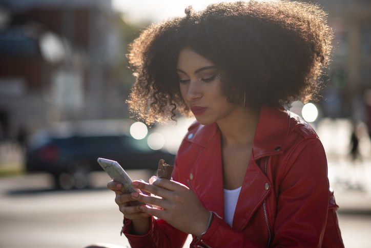 In connection - teen girl on phone in street