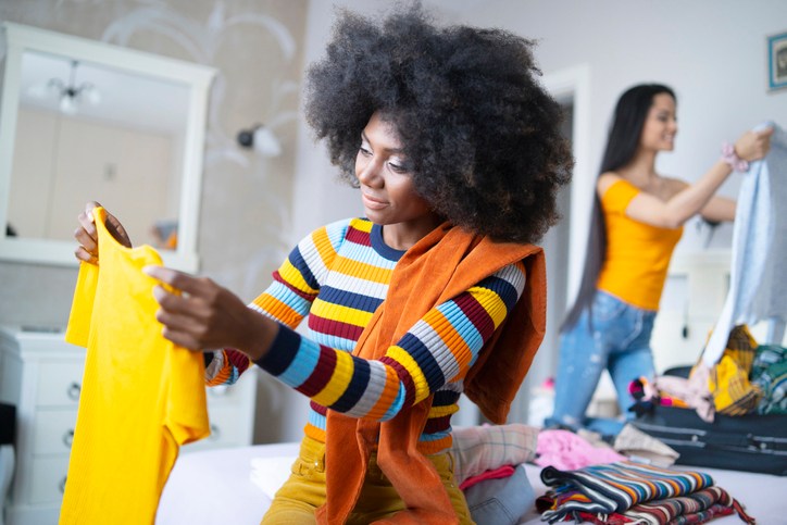 Girlfriends packing suitcases for vacations