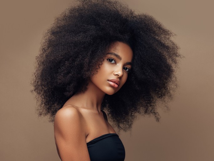 Beautiful smiling girl with curly hairstyle