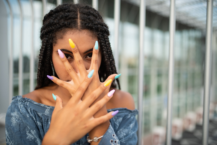 Woman covering face with hand and staring at you