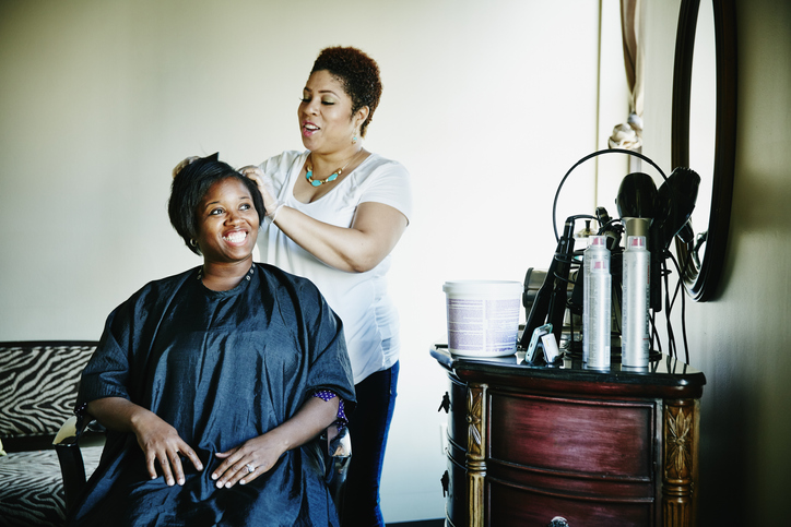 Smiling woman having haircut in salon