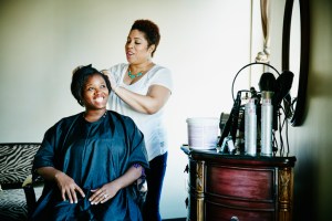 Smiling woman having haircut in salon