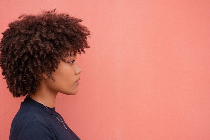 Profile View Of Woman Against Wall