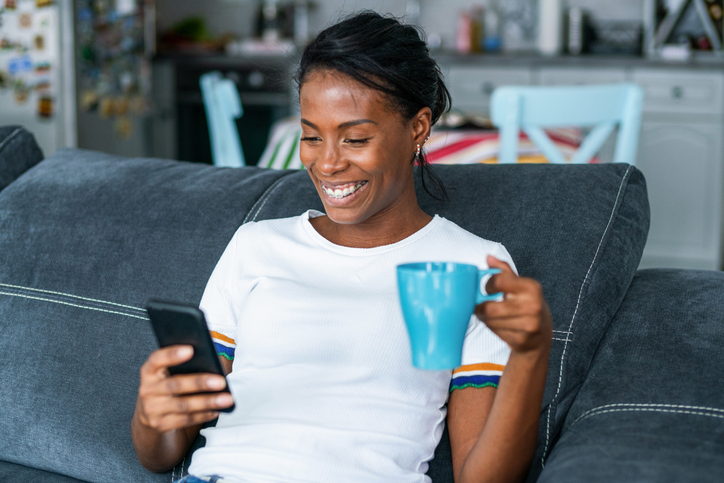 Woman using mobile phone at home.
