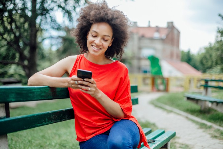Happy African American female using a smart phone
