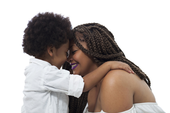 Loving son cuddling mom