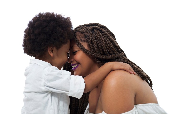 Loving son cuddling mom
