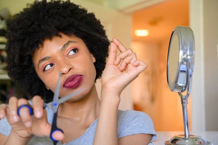 Young woman contemplating cutting her hair