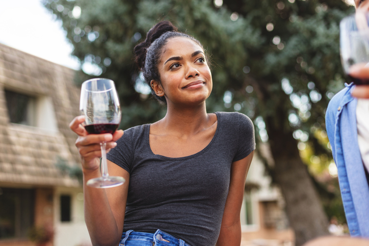 Generation Z Male and Female Pic Nic Outing in Summer Drinking Wine Outdoors