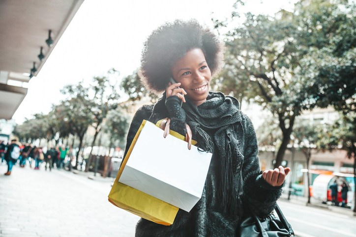 Woman goes to shopping and talking on mobile phone