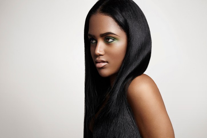 Studio portrait of young woman with straight, black hair