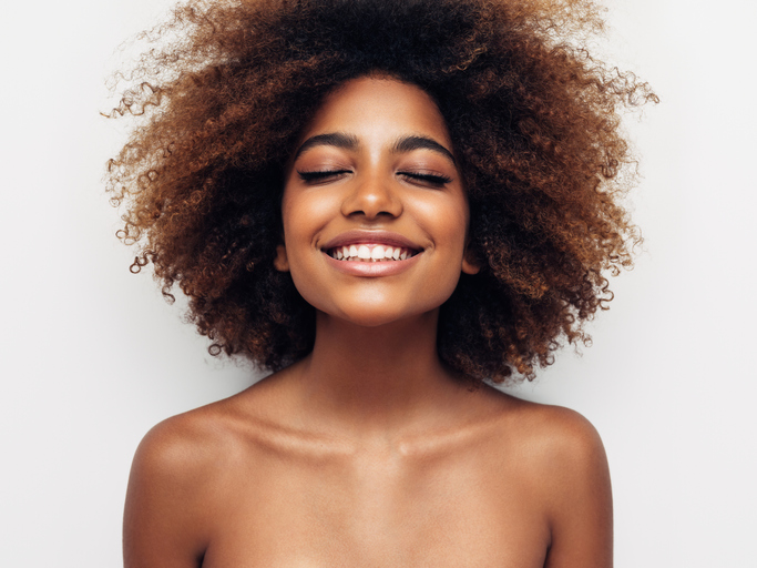 Beautiful smiling girl with curly hairstyle