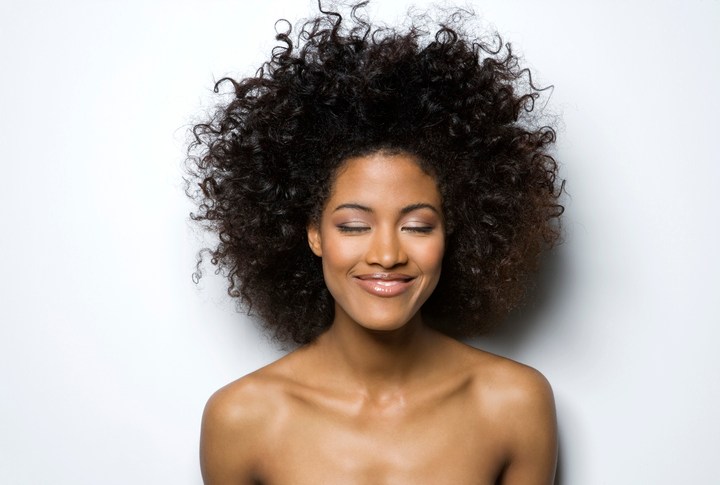 Young woman with eyes closed, smiling, close-up