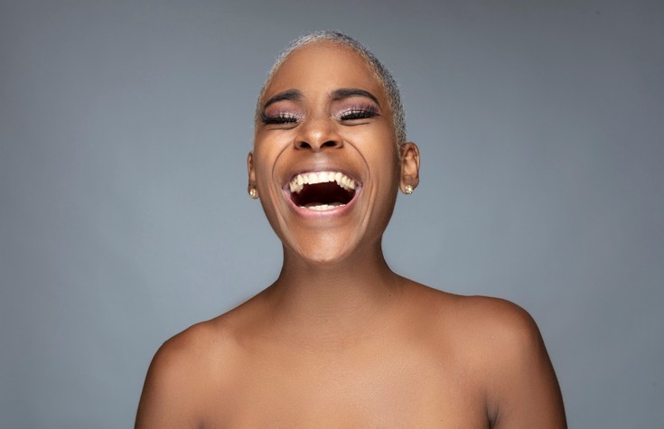 Portrait of afro young woman with short blonde hair.