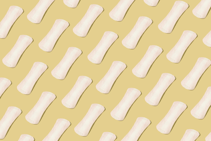 Pattern of white panty-liners on a pastel background. Concept of menstruation, ovulation, reproduction, pain and personal hygiene.