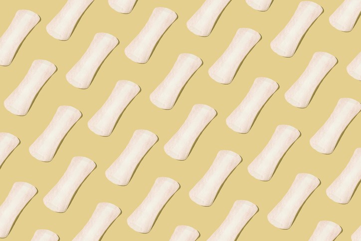Pattern of white panty-liners on a pastel background. Concept of menstruation, ovulation, reproduction, pain and personal hygiene.