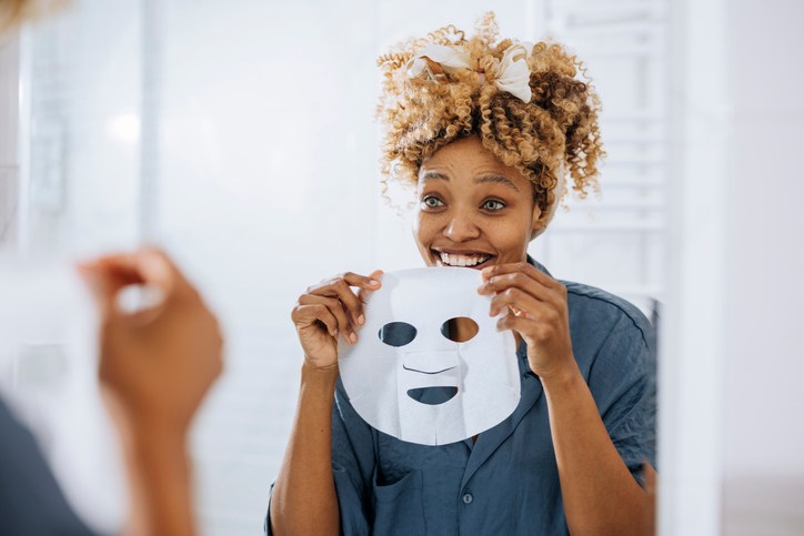 Beauty Routine: Beautiful Woman Holding and Putting a Face Mask