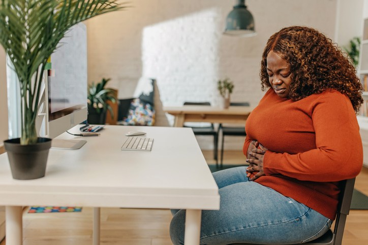 Young African-American woman having stomach pain
