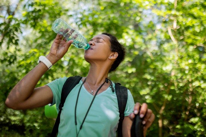 Tired Hiker Woman In Forest Hydrating