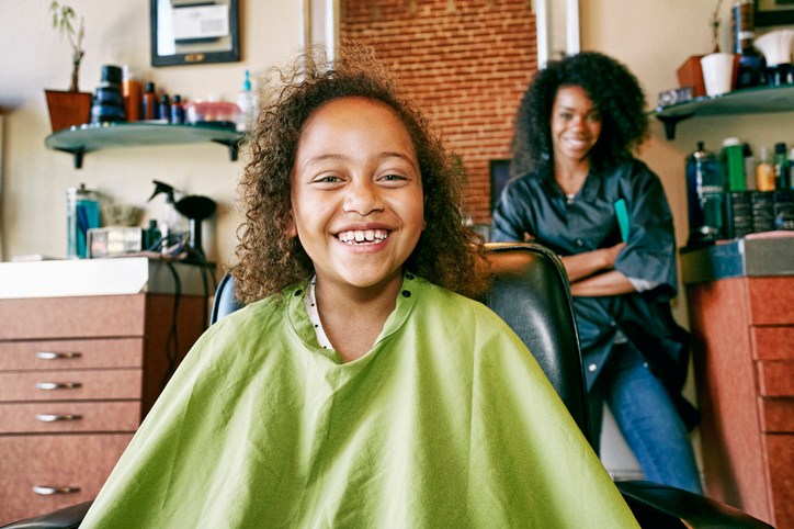 Smiling hairdresser and customer in hair salon