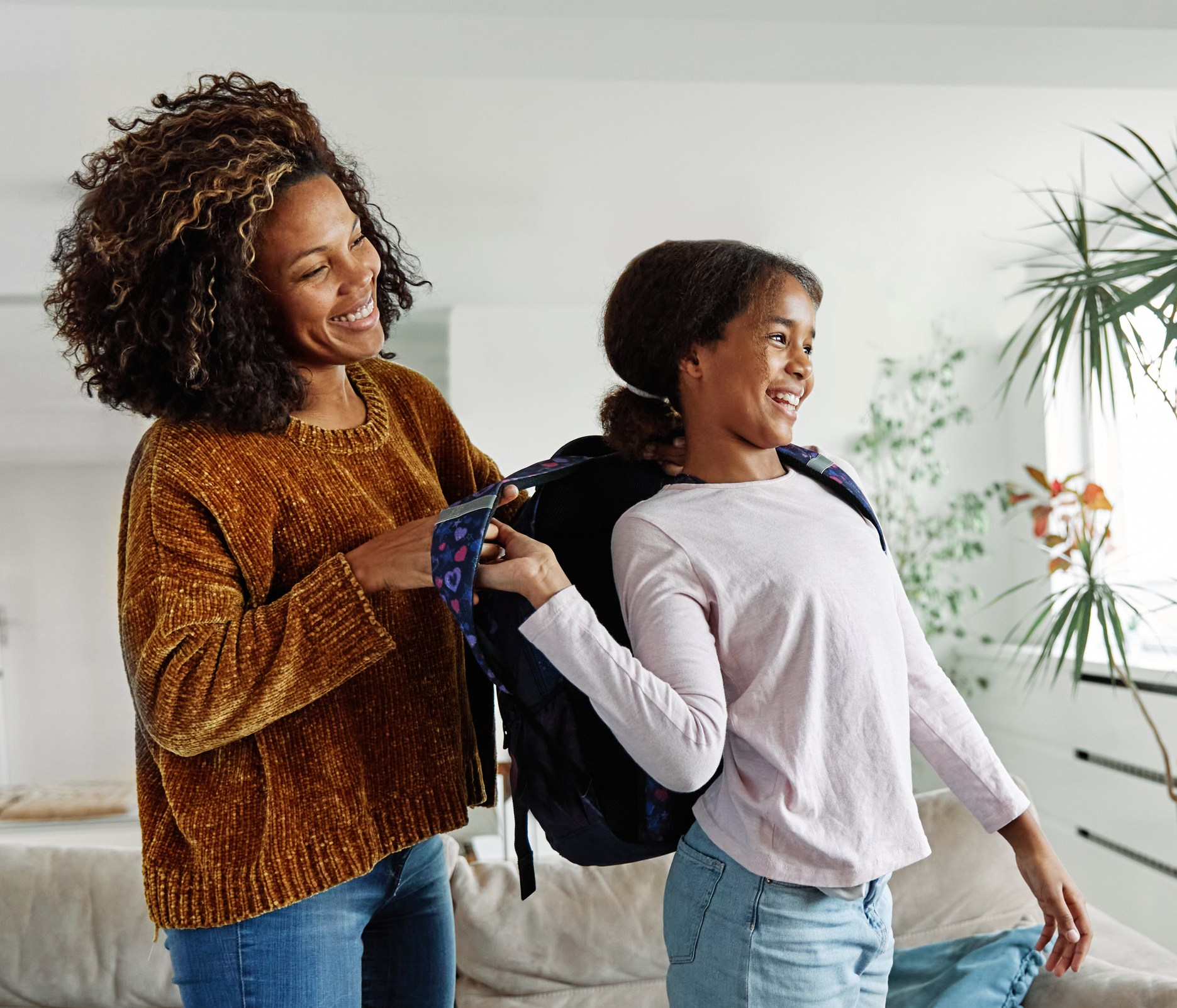 child mother family education school girl home daughter backpack help parent getting ready elementary teen morning hug love helping together black