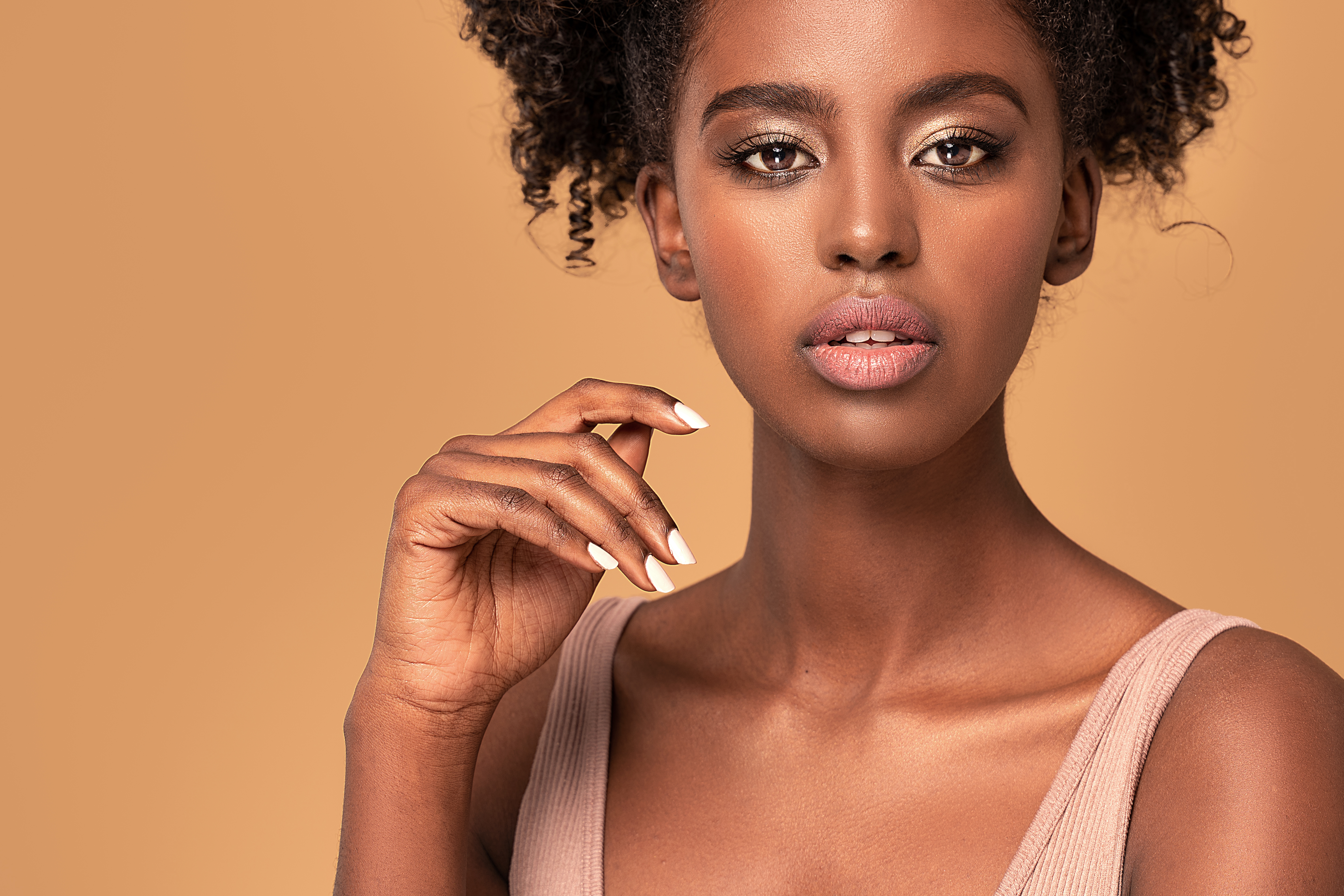 A Black woman with a white manicure