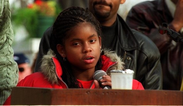 The 2000 Martin Luther King Jr. Marade, Denver Hydeia Broadbent, who was born HIV positive, (from Las Vegas, age 15) spoke to the crowd in City Park. Behind her is Michael Hancock. She was the Grand Marshall of the Marade.