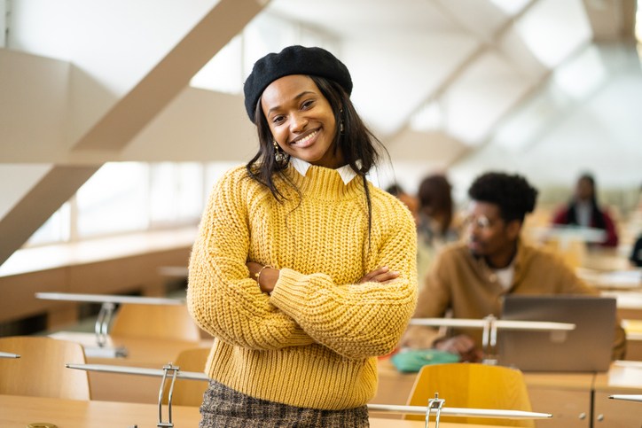 Portrait of an African female scholar standing in modern classroom