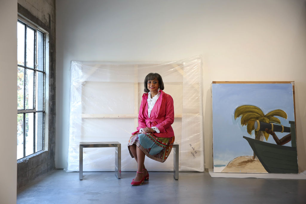 Karen Jenkins-Johnson sits for a portrait next to Enrico Rileyís ìUntitled: Witness, Triangle Tradeî, 2019 at Jenkins Johnson Gallery on Friday, January 31, 2020 in San Francisco, Calif.