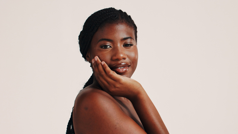 Skincare, face and portrait of black woman in studio with natural, health or wellness routine. Smile, beauty and African female person with dermatology facial treatment for glow by white background.