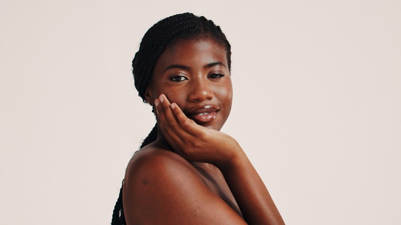Skincare, face and portrait of black woman in studio with natural, health or wellness routine. Smile, beauty and African female person with dermatology facial treatment for glow by white background.
