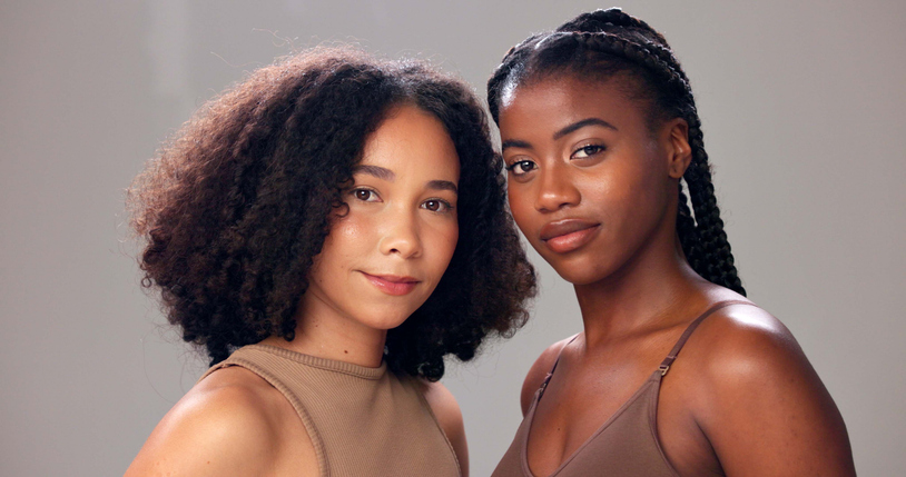 Portrait, cosmetics and women in studio, beauty and aesthetic with glow on gray background. Dermatology, wellness or people with shine, shampoo and natural hair with volume, texture or healthy scalp