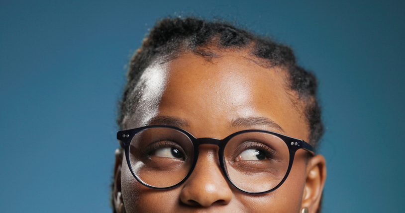 Glasses, thinking and vision with black woman in studio for optometry or prescription frame lenses. Eyewear, ideas and sight with African person on blue background for ophthalmology consultation