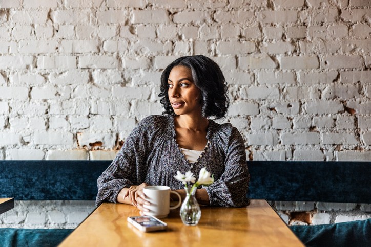 Young woman sitting alone in restaurant