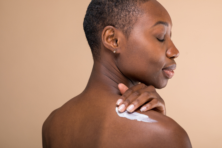 Woman applying skincare cream photo