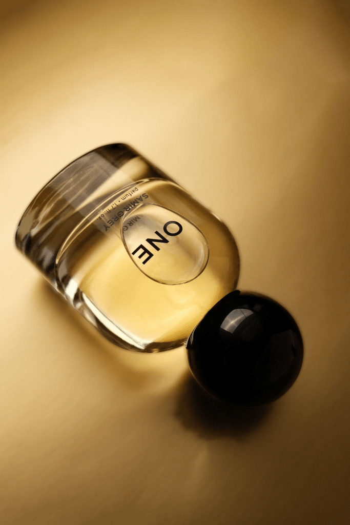 A glass bottle with the word "ENO" printed on it against a golden background.