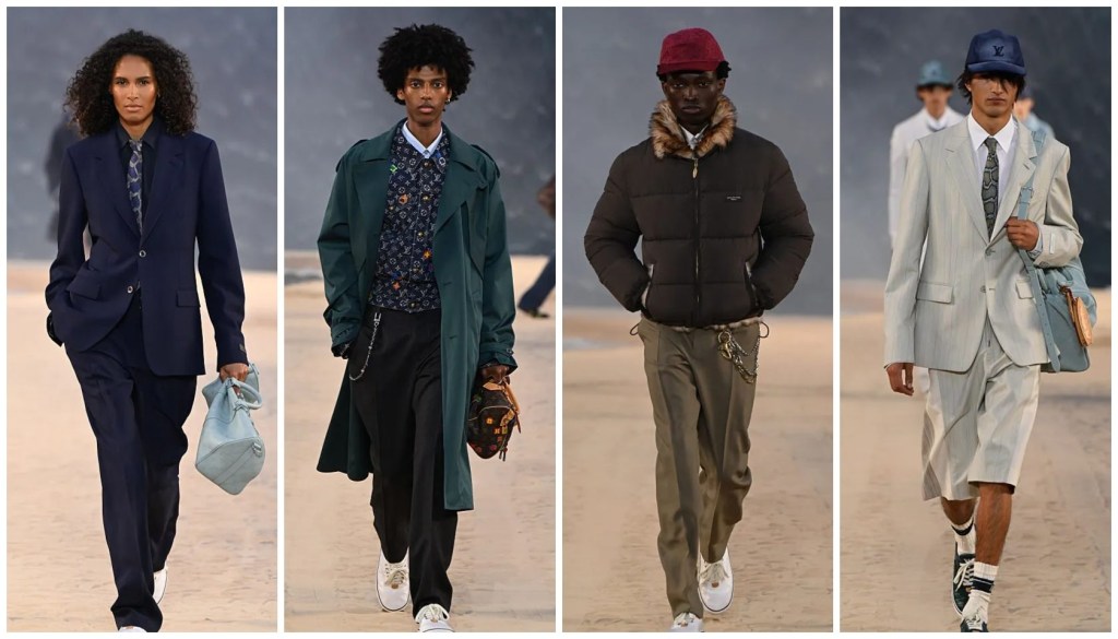 Missy Elliot Looks 'Supa Dupa Fly' At The 2027 Louis Vuitton Menswear Show Four fashion models wearing stylish outfits on a desert landscape, including a navy blue coat, green jacket, brown puffer coat, and light gray suit.